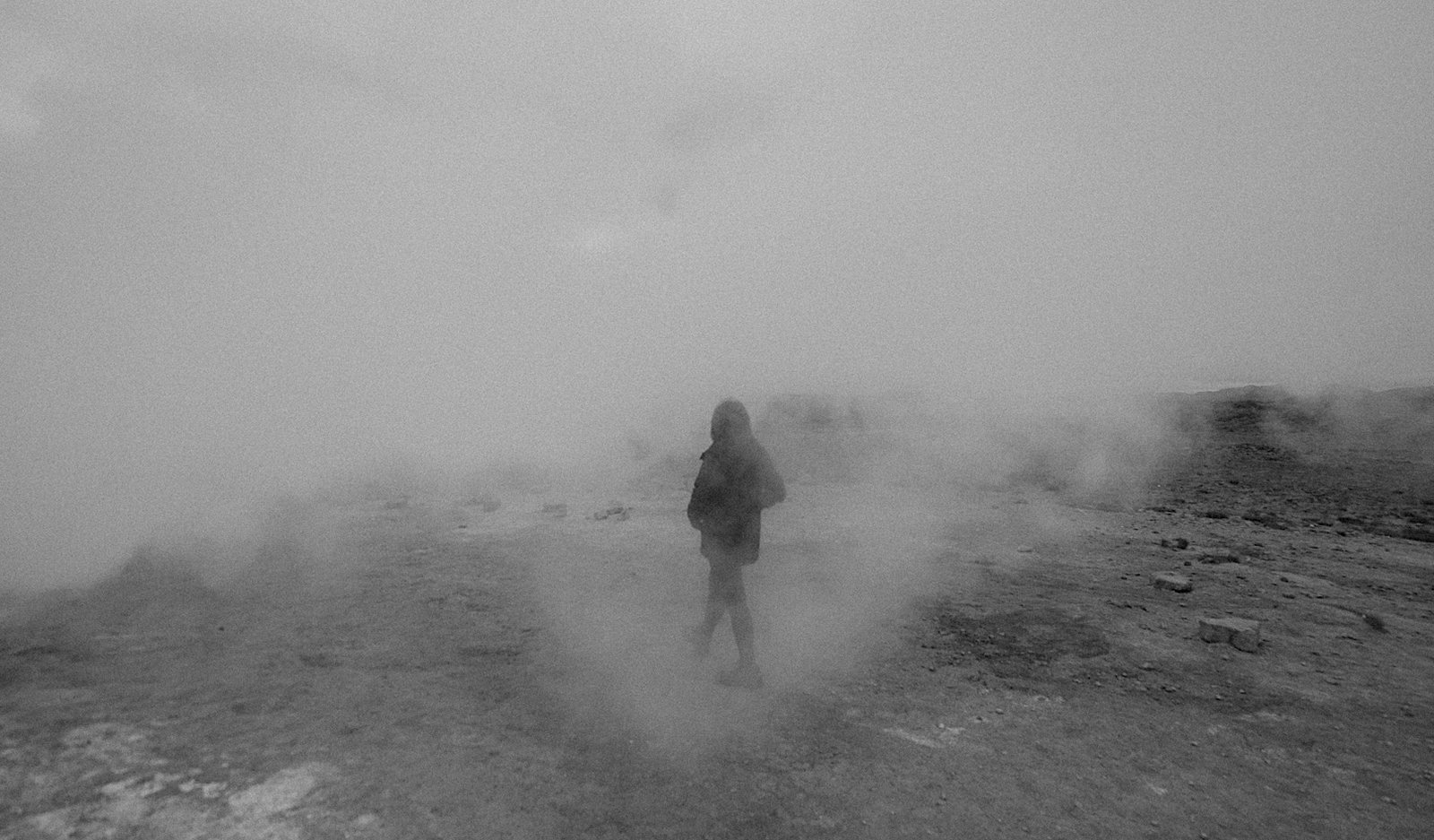 Sarah Chang walking through drifting steam on a volcanic field